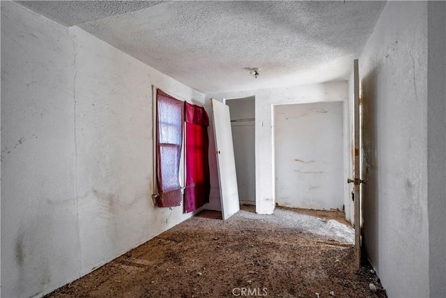 unfurnished bedroom featuring a textured ceiling