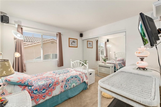 bedroom with light carpet and a closet