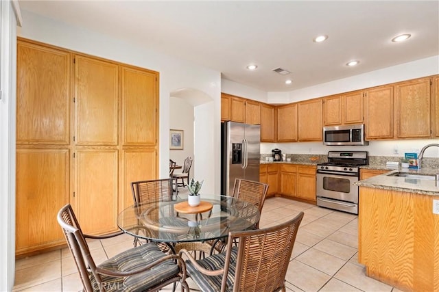 kitchen featuring appliances with stainless steel finishes, visible vents, a sink, and light tile patterned floors