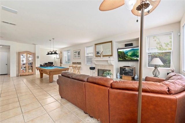 living room with plenty of natural light, visible vents, billiards, and light tile patterned floors