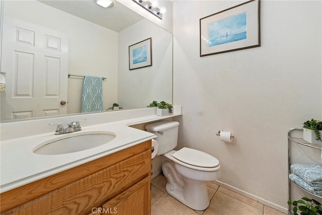 half bath with baseboards, vanity, toilet, and tile patterned floors