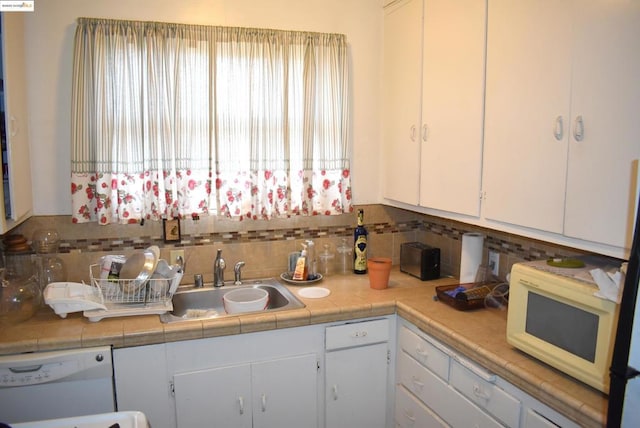 kitchen featuring white appliances and white cabinets