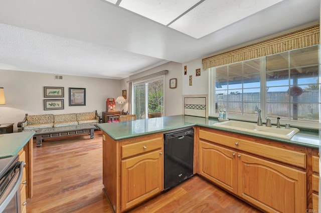 kitchen featuring sink, black dishwasher, kitchen peninsula, light hardwood / wood-style floors, and stove