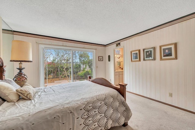 carpeted bedroom with crown molding, a textured ceiling, and access to outside