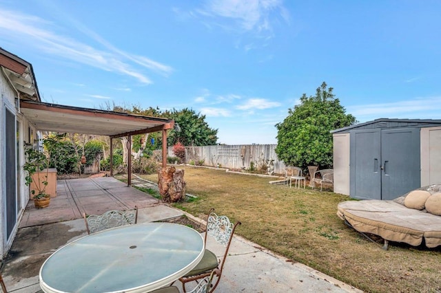 view of yard with a shed and a patio area