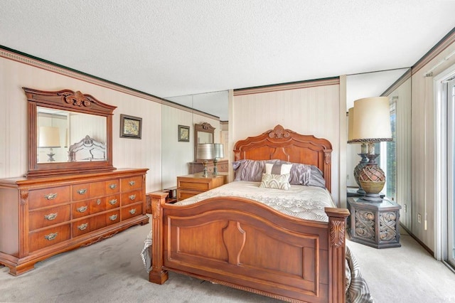 carpeted bedroom featuring ornamental molding and a textured ceiling