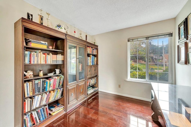 sitting room with dark hardwood / wood-style floors and a textured ceiling