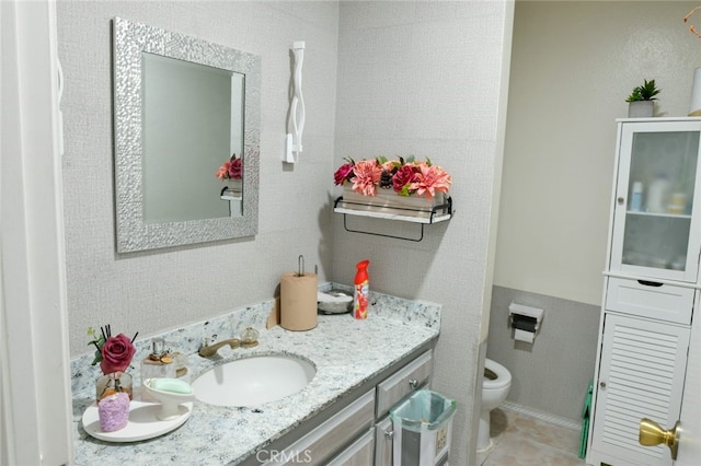 bathroom with vanity, tile patterned floors, and toilet