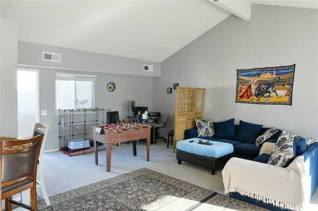 carpeted living room with high vaulted ceiling and beam ceiling