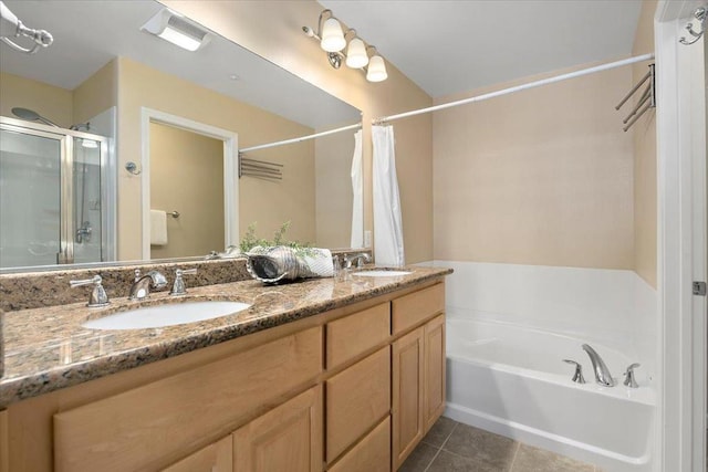 bathroom with independent shower and bath, vanity, and tile patterned floors