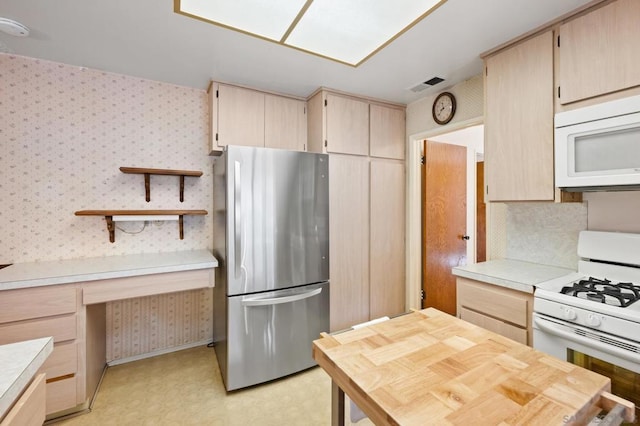 kitchen with white appliances and light brown cabinets