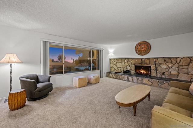 living room featuring a fireplace, carpet floors, and a textured ceiling