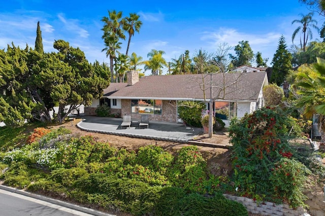 back of property with a patio