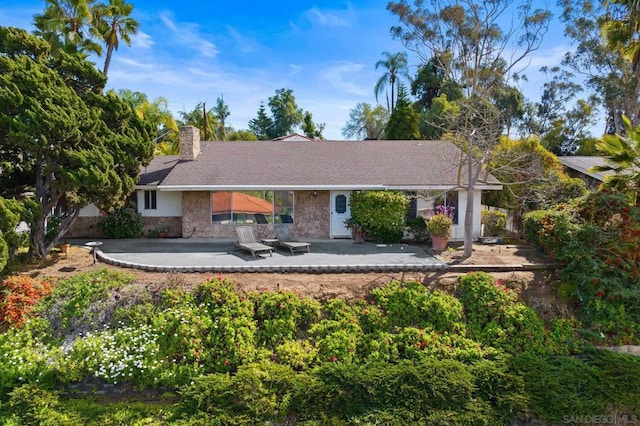 back of property with a patio