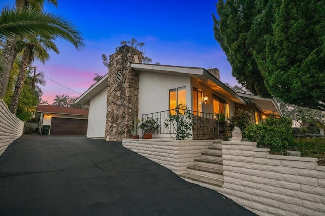 property exterior at dusk with a garage