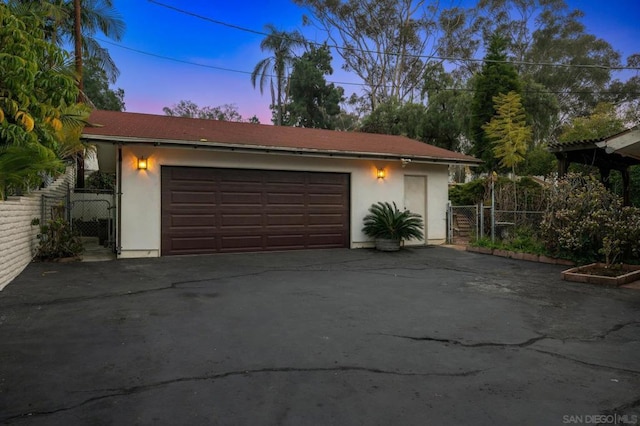 view of garage at dusk