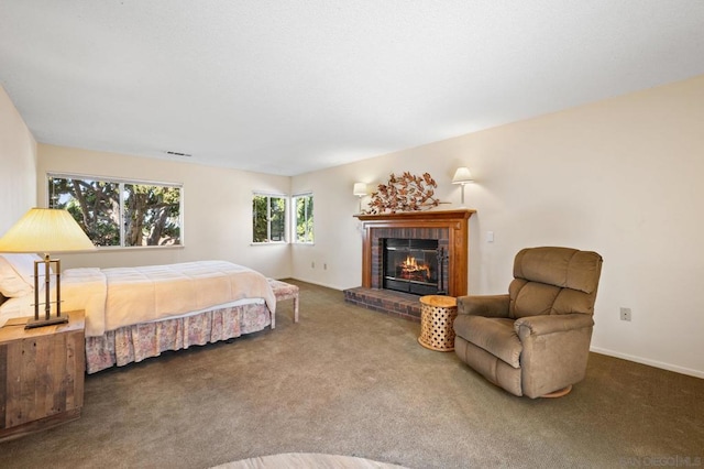 carpeted bedroom featuring a fireplace