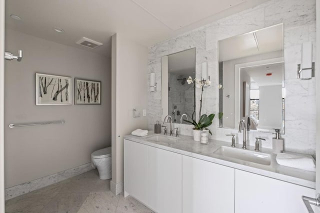 bathroom featuring walk in shower, vanity, and toilet