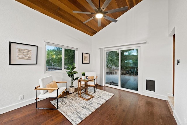 living area with ceiling fan, high vaulted ceiling, dark hardwood / wood-style floors, and wood ceiling