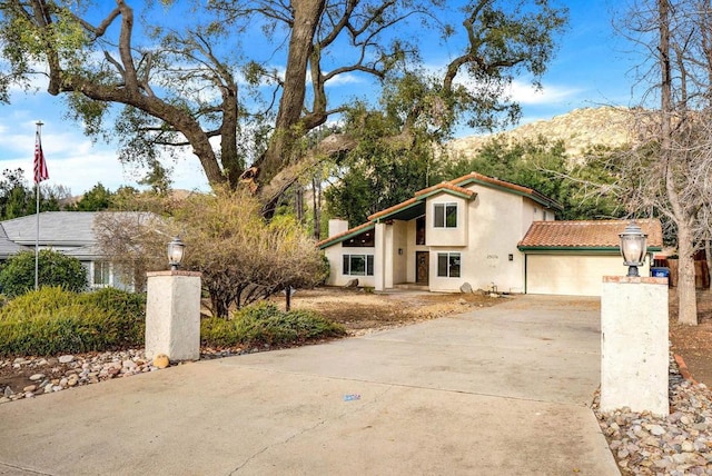 mediterranean / spanish home with a mountain view and a garage