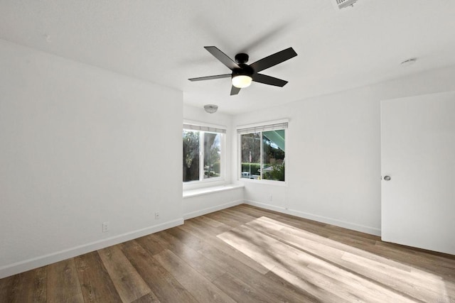 unfurnished room with hardwood / wood-style floors and ceiling fan