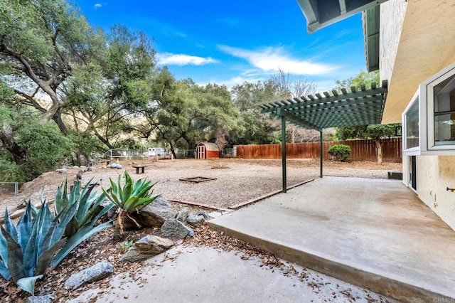 view of yard with a storage unit, a pergola, and a patio area