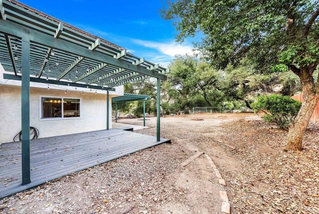 view of yard featuring a wooden deck and a pergola