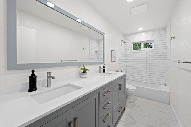 full bathroom featuring vanity, toilet, tiled shower / bath combo, and tile patterned flooring