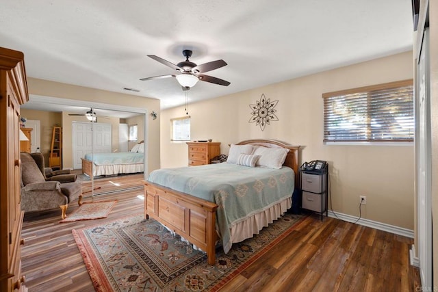 bedroom featuring dark wood-type flooring, a closet, and ceiling fan