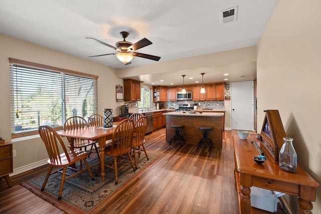 dining space featuring hardwood / wood-style flooring and ceiling fan