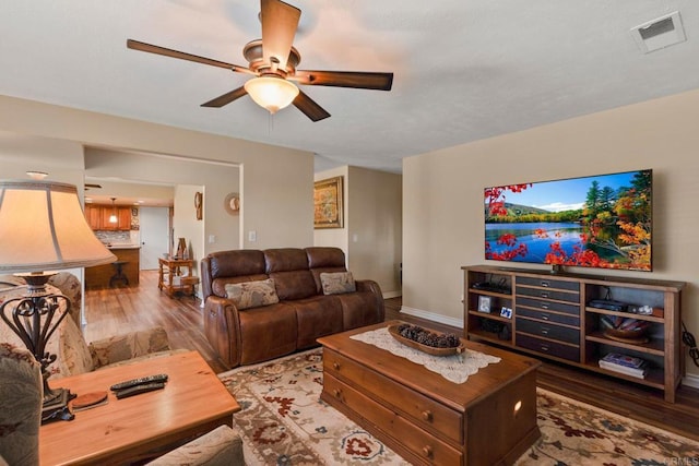 living room featuring ceiling fan and wood-type flooring