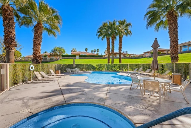 view of pool featuring a hot tub and a patio area