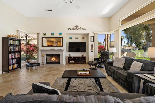 tiled living room featuring ceiling fan