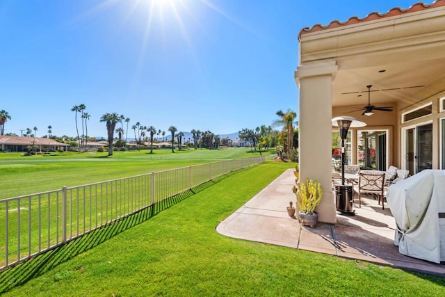 view of yard with ceiling fan and a patio area