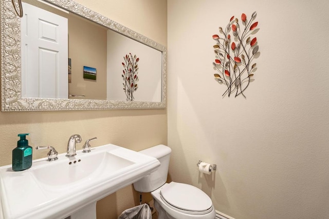 bathroom with toilet and sink