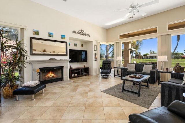 living room featuring light tile patterned floors and ceiling fan