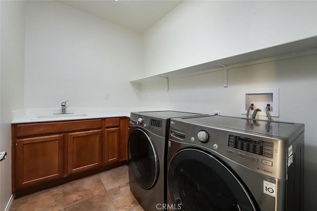 laundry area featuring cabinet space, washing machine and dryer, and a sink