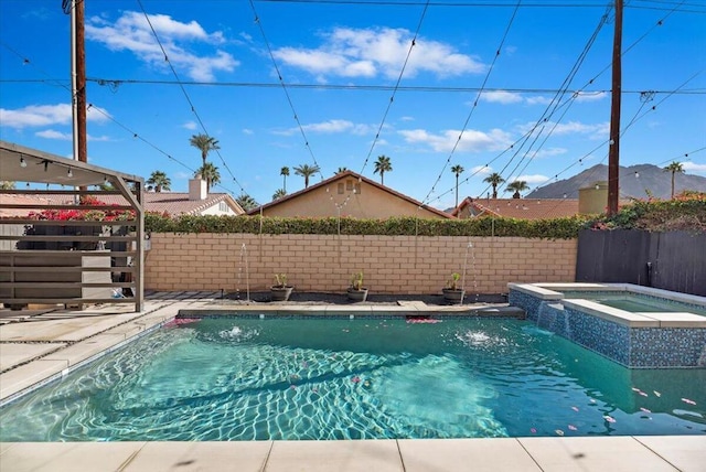 view of swimming pool with pool water feature and an in ground hot tub