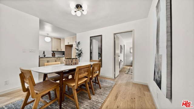 dining area with sink and light hardwood / wood-style floors