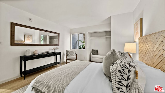 bedroom featuring hardwood / wood-style floors and a closet