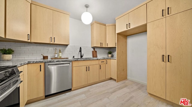 kitchen with appliances with stainless steel finishes, decorative light fixtures, light brown cabinetry, and sink