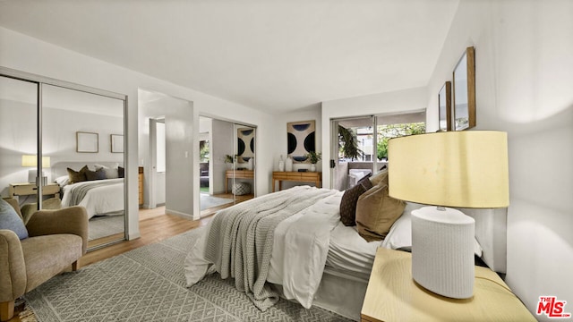 bedroom featuring access to outside and hardwood / wood-style floors