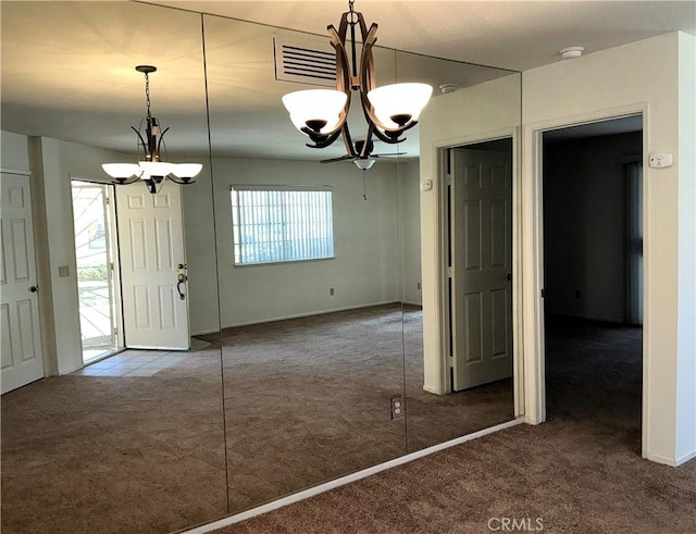 unfurnished dining area with an inviting chandelier and carpet flooring