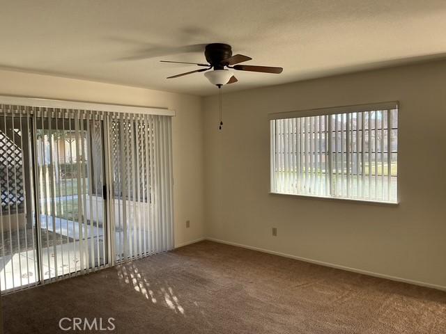 unfurnished room featuring carpet floors and ceiling fan