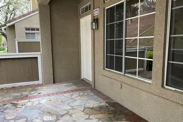 view of exterior entry with a patio