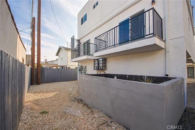 view of side of home featuring a balcony