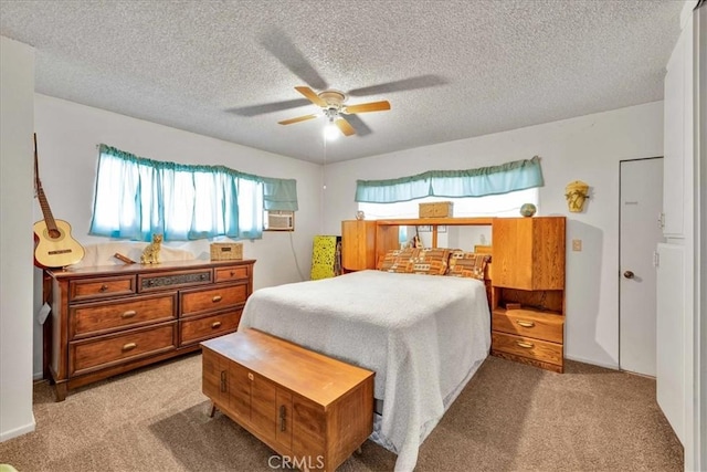 bedroom featuring ceiling fan, light carpet, and a textured ceiling