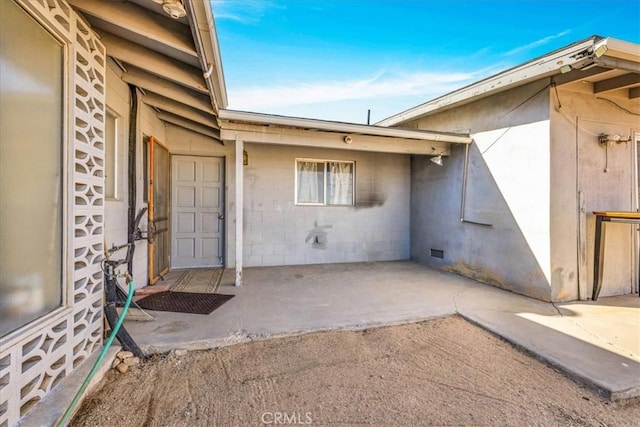 entrance to property with a patio