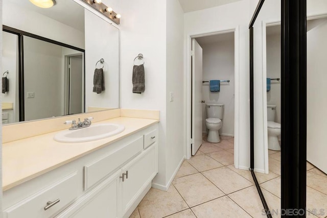 bathroom with tile patterned floors, toilet, and vanity