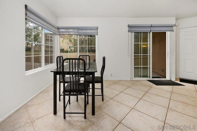 dining space featuring light tile patterned floors